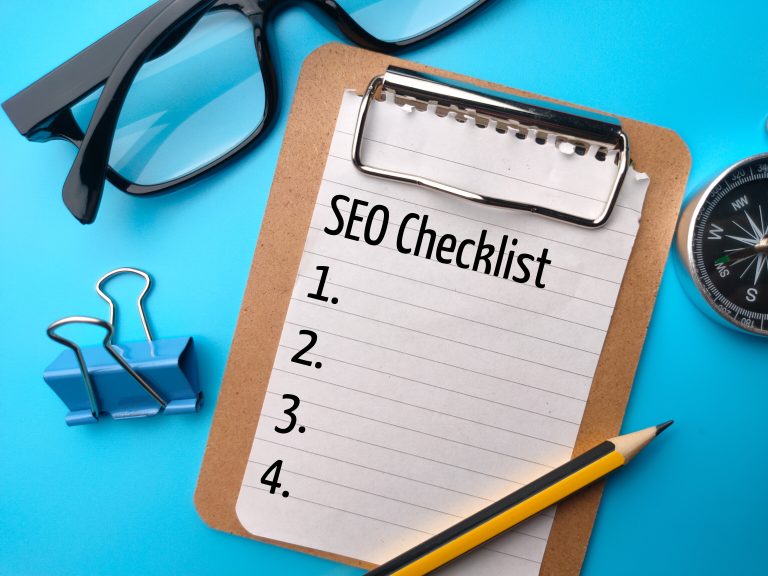 SEO checklist written on paper with office stationery