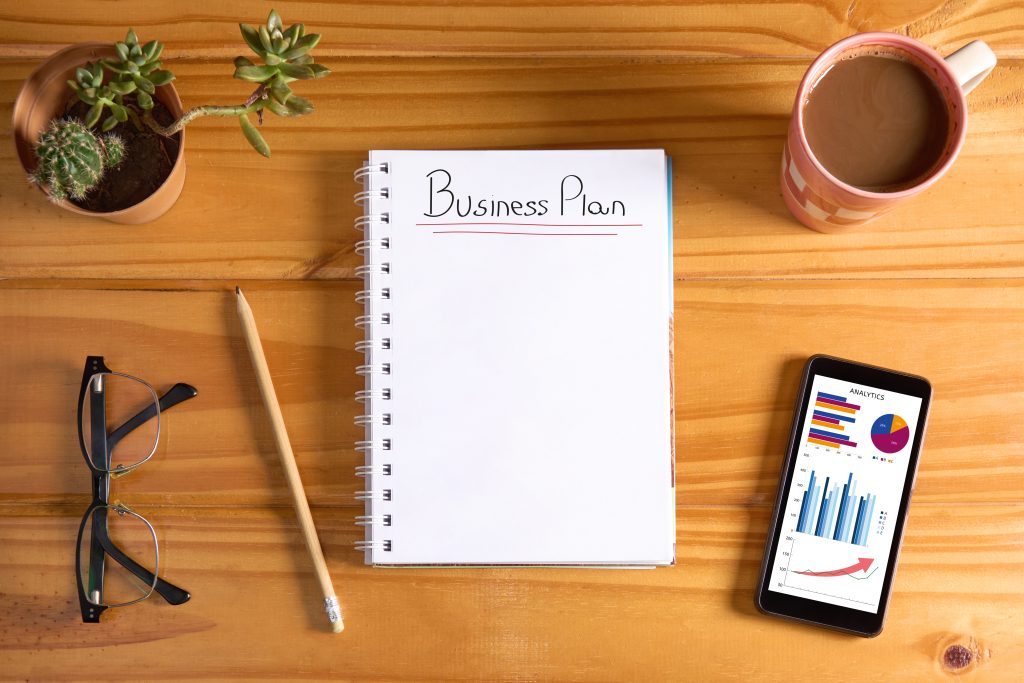 Business plan notebook and phone on a desk
